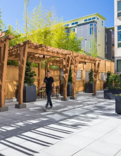 A patio with tables and chairs in an apartment building.