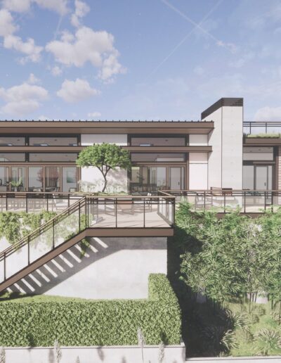 Modern one-story house with large windows and a flat roof, surrounded by landscaped gardens and a small staircase leading to a grassy terrace.